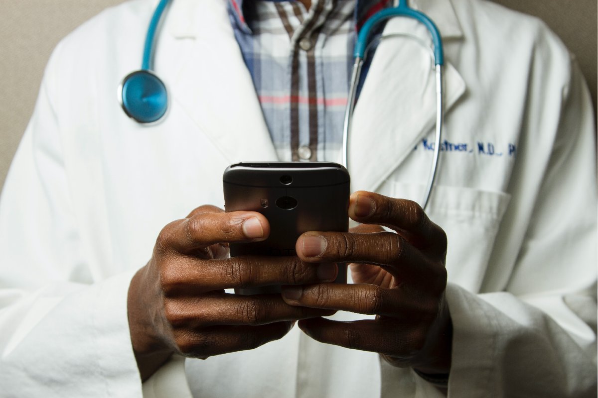 Closeup of a physician holding a mobile device