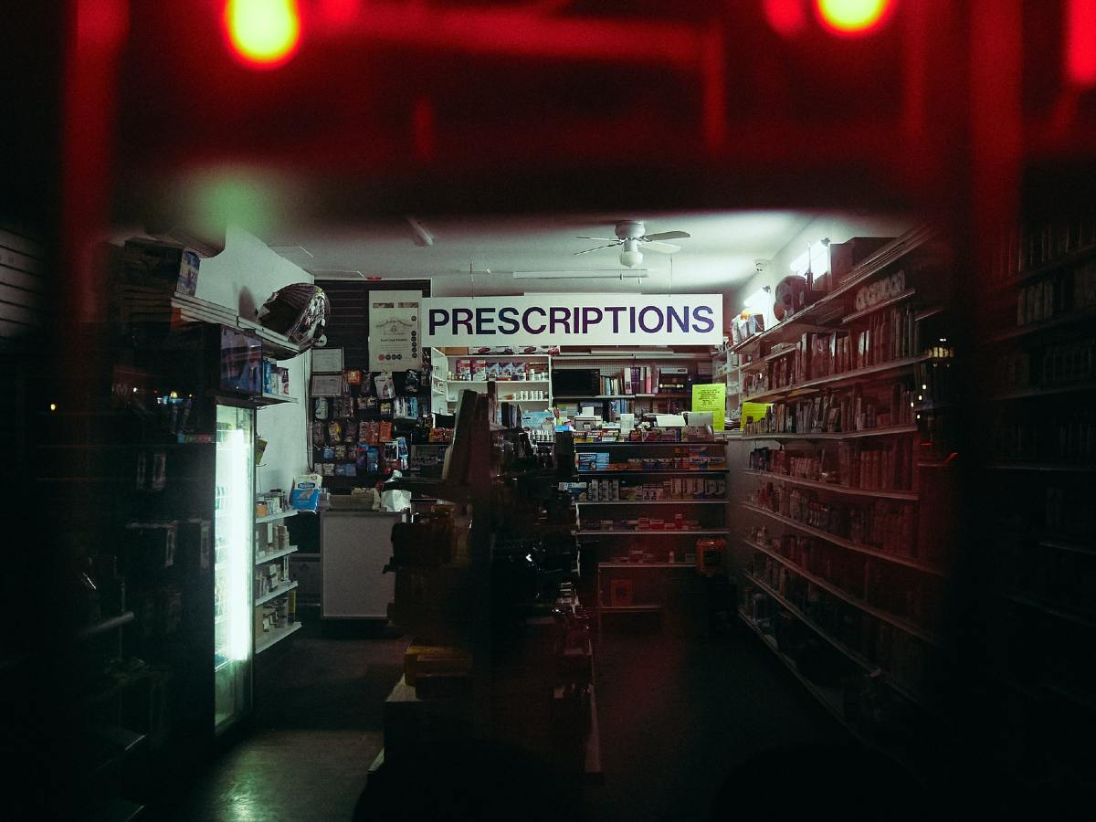 A nighttime view into a dimly lit pharmacy