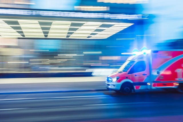 A blurred image of an ambulance suggests the theme of a Rural Emergency Hospital