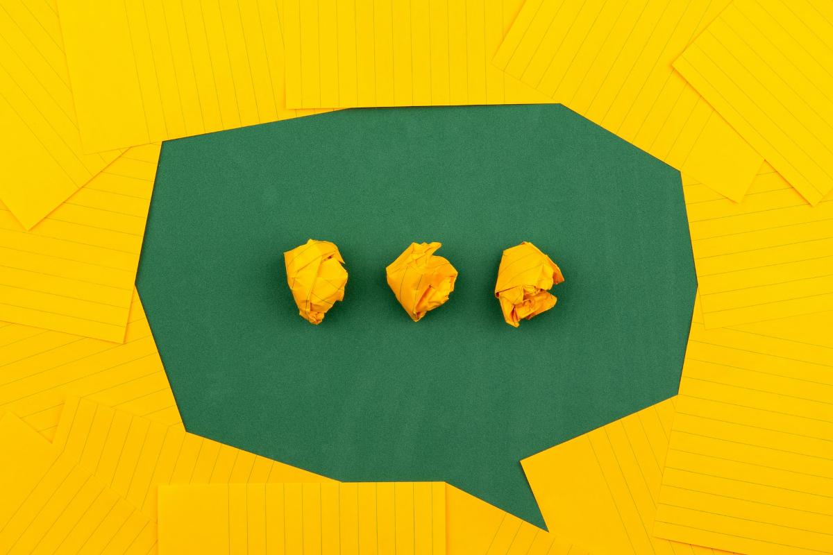A 3D construction by Volodymyr Hryshchenko -- green and yellow papers forming a conversation bubble -- illustrate the idea of ChatGPT.