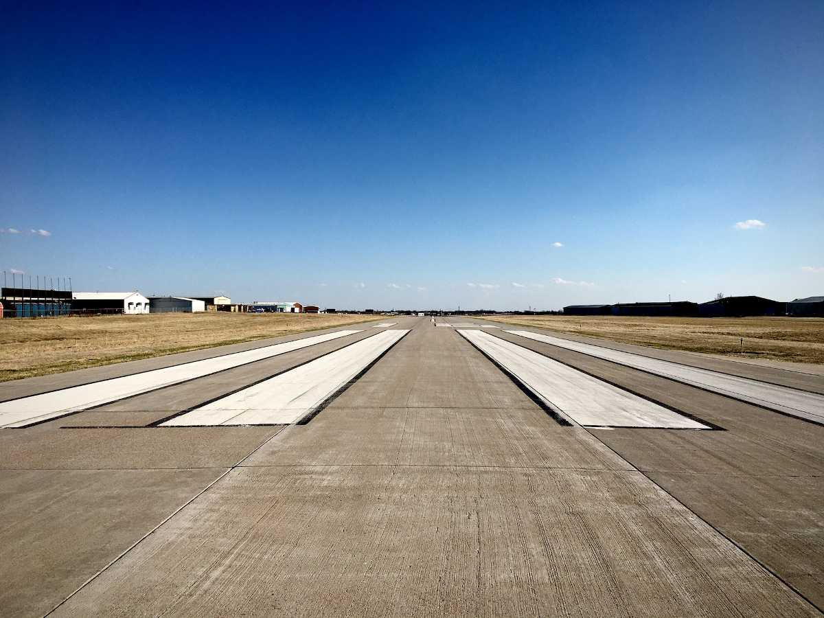 A look down the runway at a small airport illustrates the idea that the federal government subsidizes airline monopolies while insisting on competition in healthcare