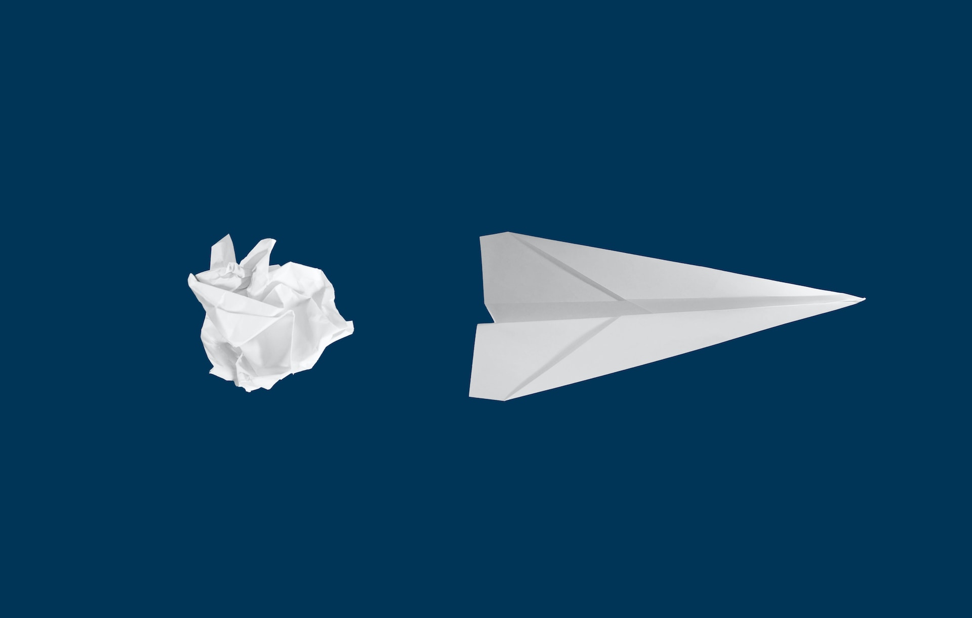 Crumpled paper next to a paper airplane illustrates the concept of CMS's new AHEAD model.