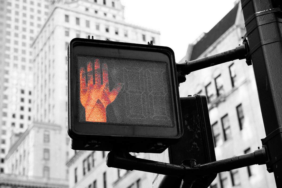 A NYC pedestrian "stop" sign illustrates the idea of delayed care for Medicare Advantage patients with prior authorization requirements. Unsplash photo by Kai Pilgerl