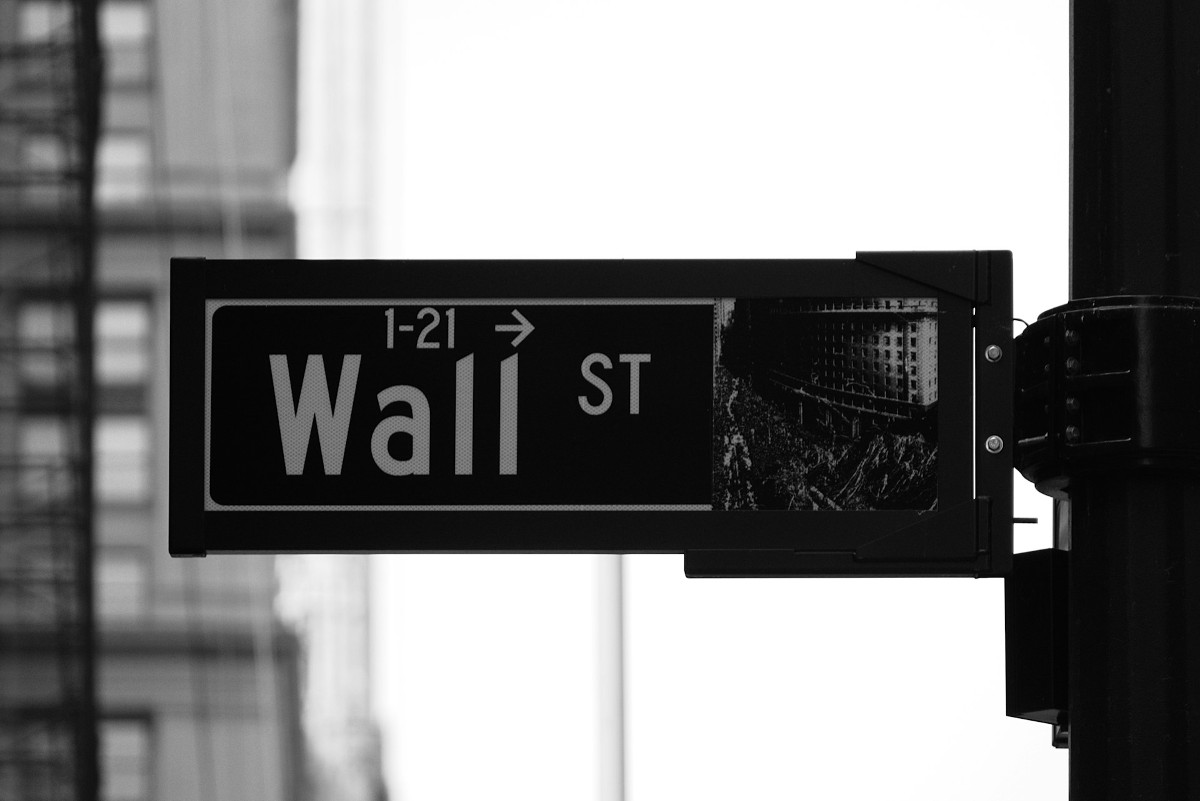 A Wall Street street sign, in black and white, illustrates the idea that hospital operating margins are tenuous, while investment income provides some cushion.